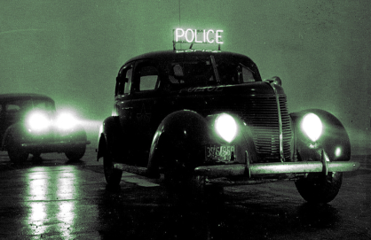 Police two old cars at night, the one
in front with a